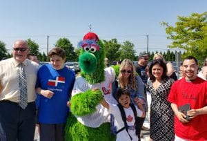children and teachers pose with mascot